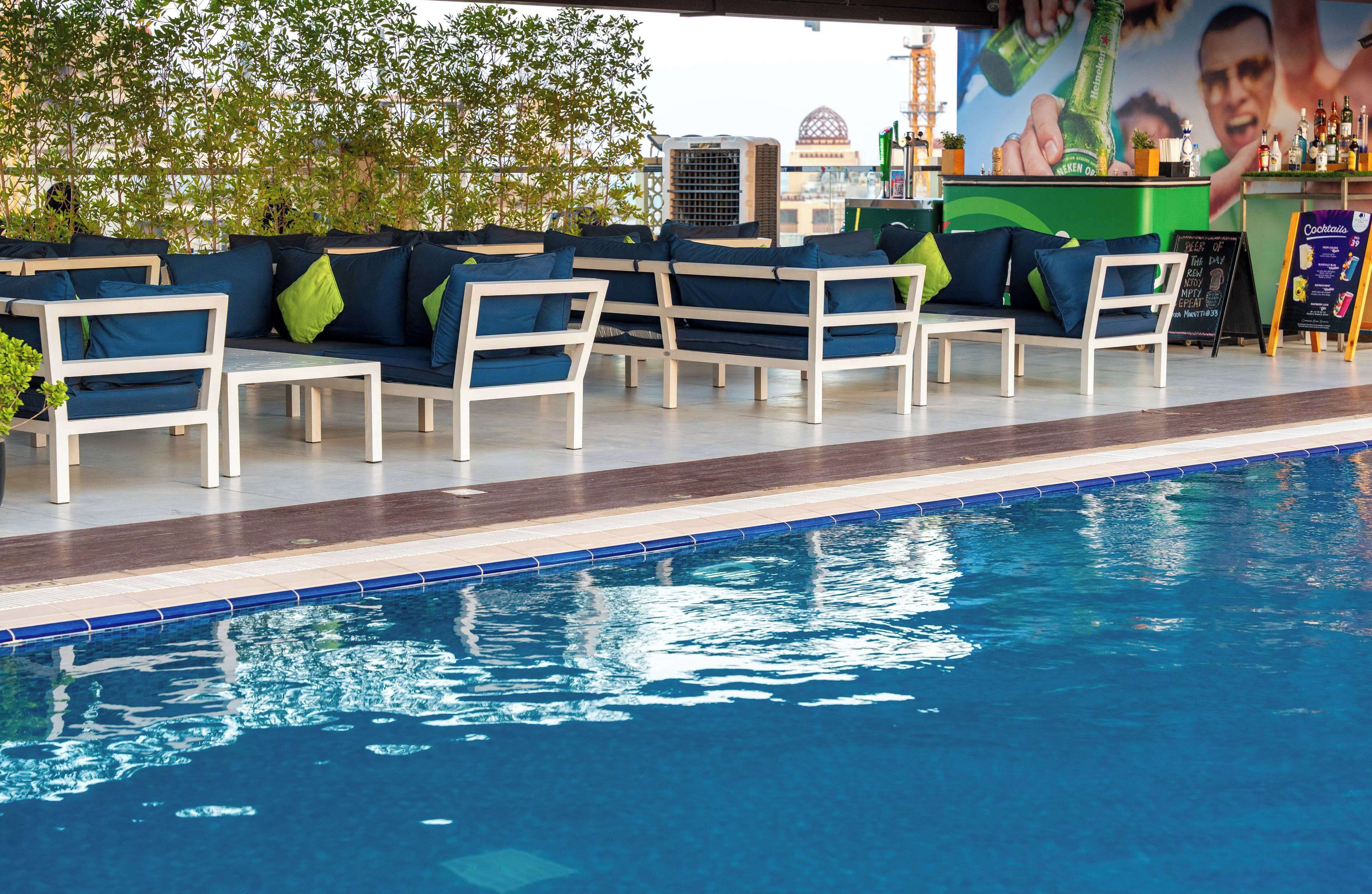 outdoor pool, open 6:00 am to 10:00 pm, pool umbrellas, pool loungers