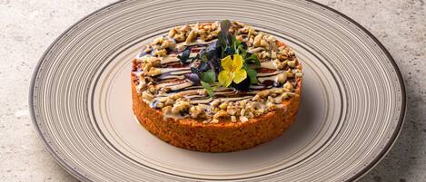 A round plate with a textured design, placed on a speckled surface.