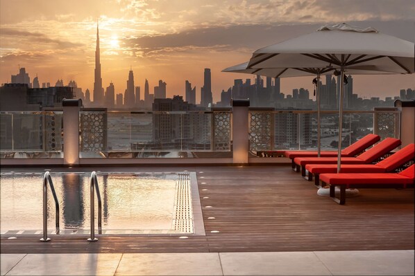 Outdoor pool, open 6:00 AM to 10:00 PM, pool umbrellas, sun loungers