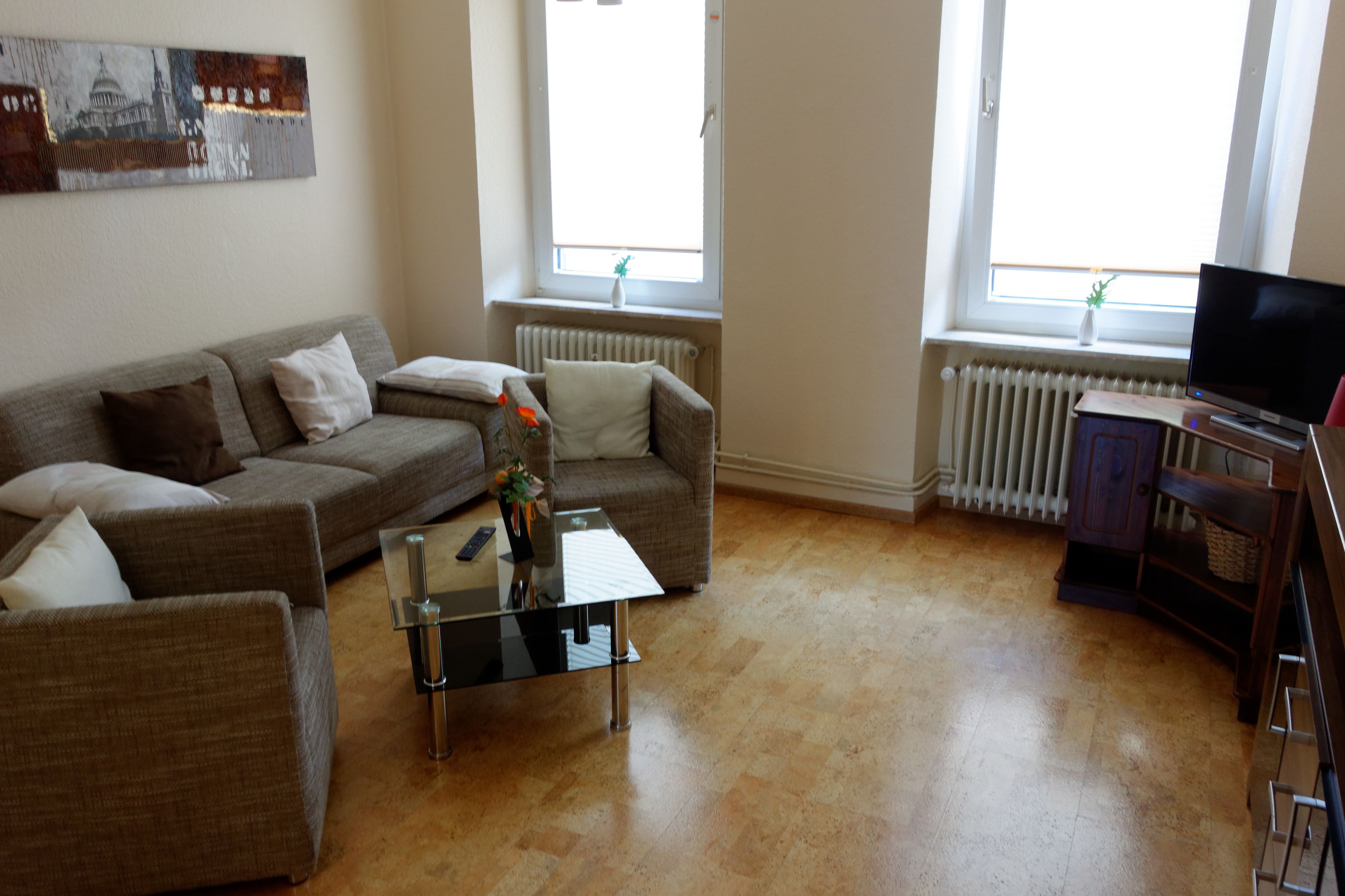 comfort apartment, ensuite, garden view | living room | flat-screen tv