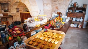 A breakfast buffet with various food items and condiments. - Masseria Pilano (Crispiano)
