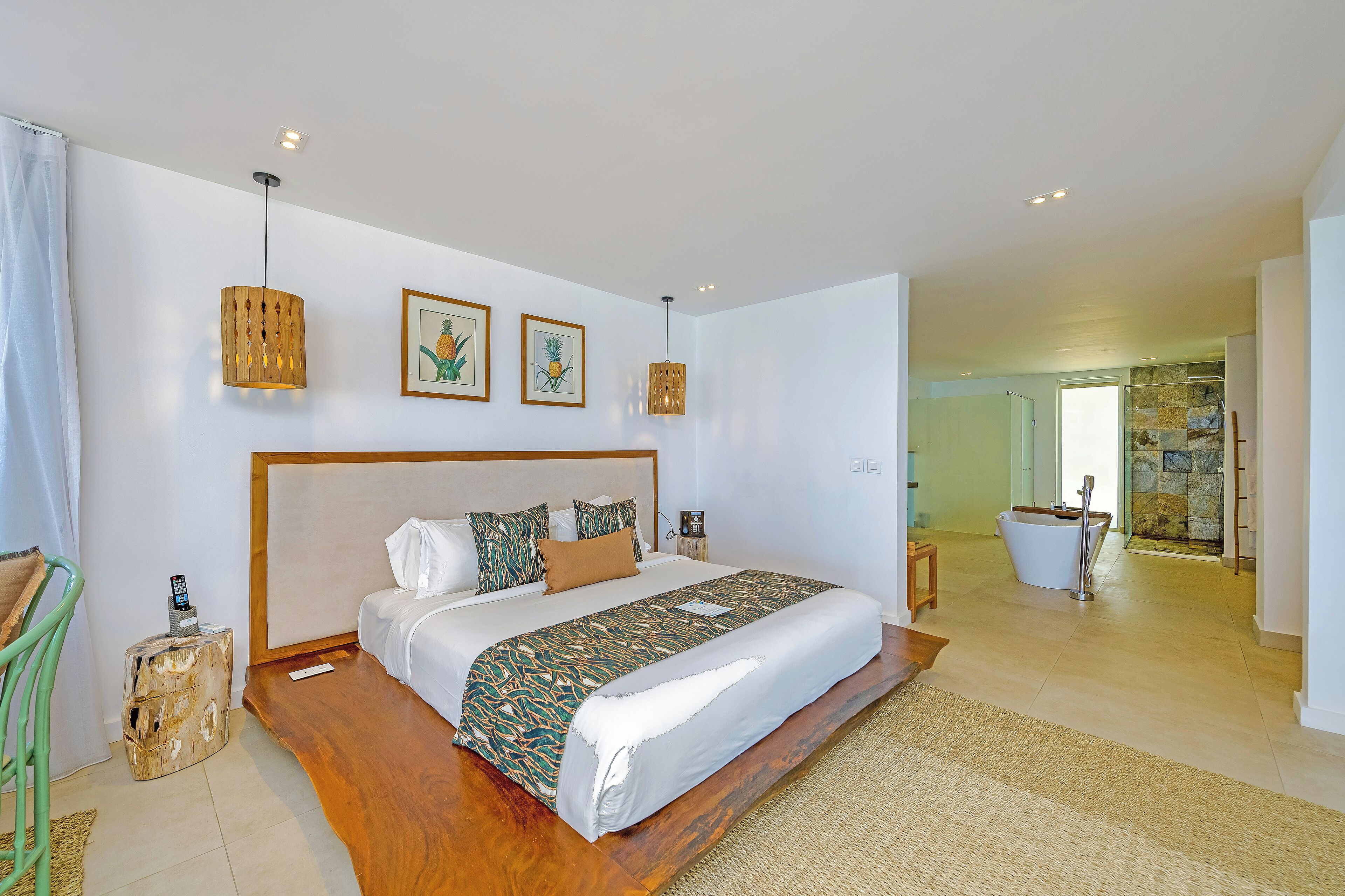 A spacious bedroom with a large bed, wooden headboard, and a small bedside table.