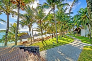 A wooden deck, palm trees, and a beach view. - Seasense Boutique Hotel & Spa (Belle Mare)