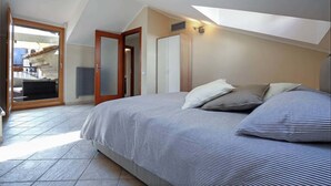 A bedroom with a bed, a door, and a view of a balcony. - B&B Portanova (Salerno)