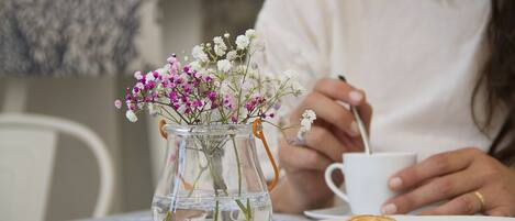 A clear glass vase with flowers on a table.