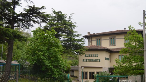 A building labeled "Albergo Ristorante" with a garden area in front. - Albergo Padellino (Vaglia)