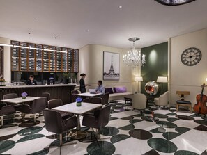 A hotel lobby with a bar area, seating arrangements, a chandelier, and a clock on the wall. - Mercure Shanghai Hongqiao Central (Shanghai)