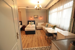 Relax in a warm and inviting space with a comfortable bed, sofa, and dining table.