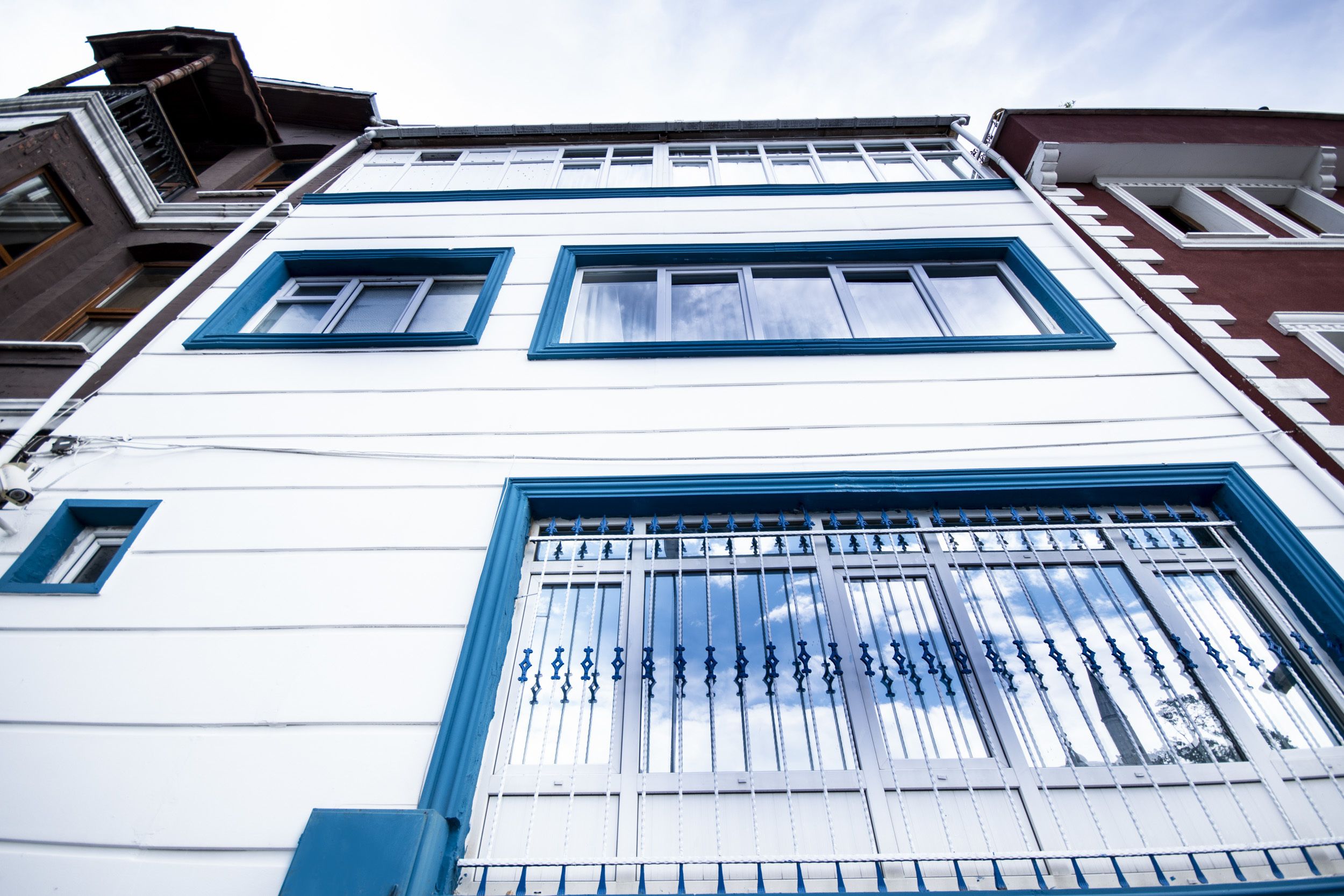 A building with multiple windows and a metal gate.
