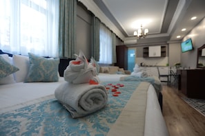 Relax in this inviting room with a comfortable bed, kitchenette, and TV.