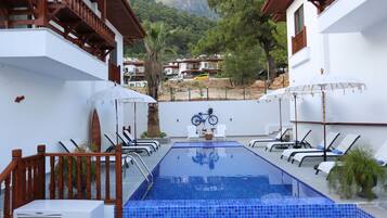 Seasonal outdoor pool, open 8:30 AM to 7:30 PM, pool umbrellas