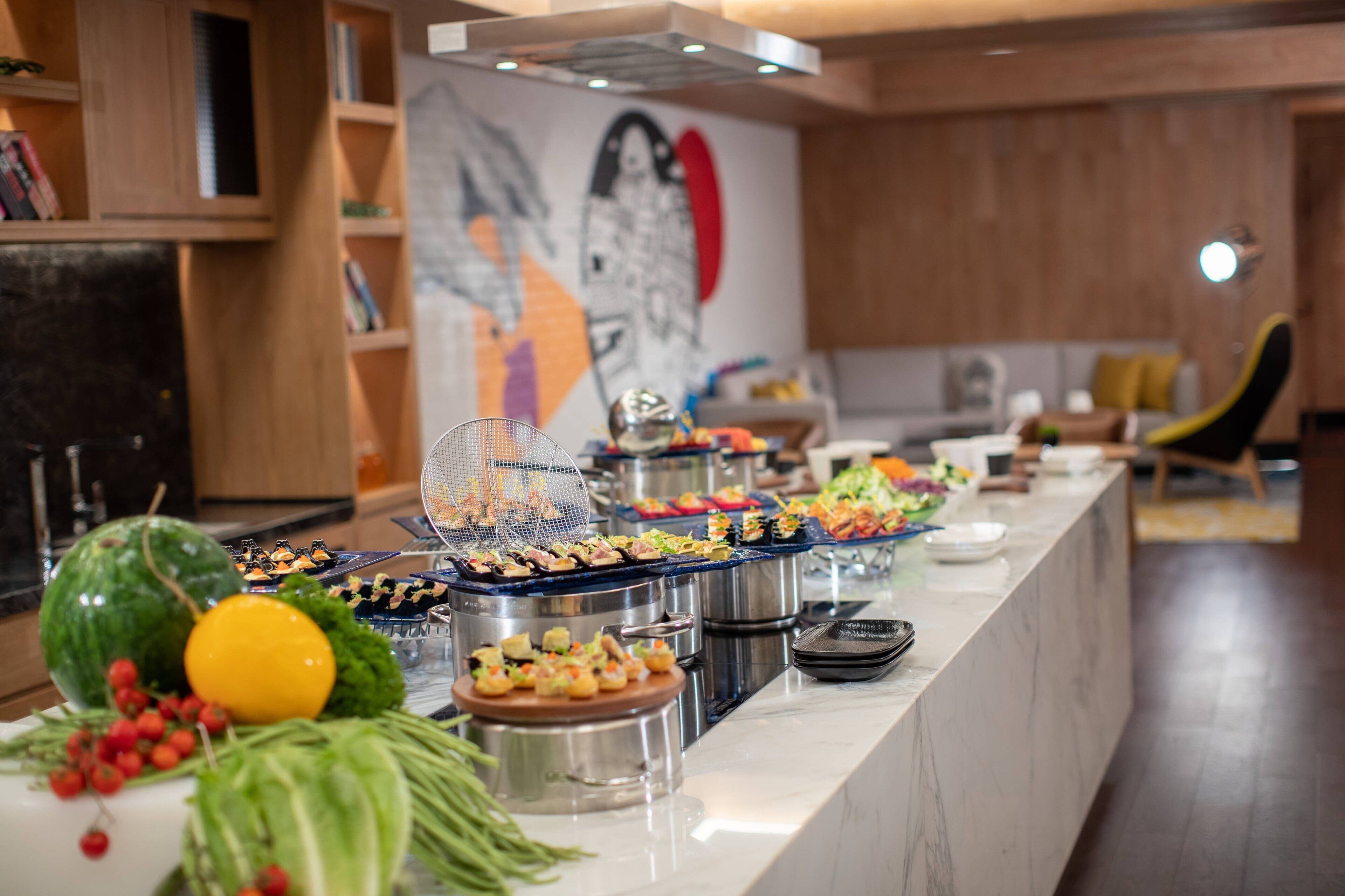 A buffet setup with various food items and a decorative centerpiece.