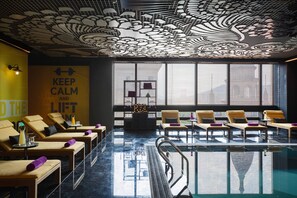 Indoor pool, open 9:00 AM to 9:00 PM, pool loungers, lifeguards on site