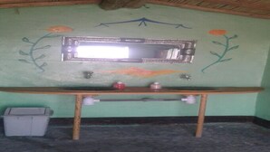 A bathroom with a wooden vanity, a mirror, and a sink. - Locals Under Stars Trips (M'Hamid El Ghizlane)