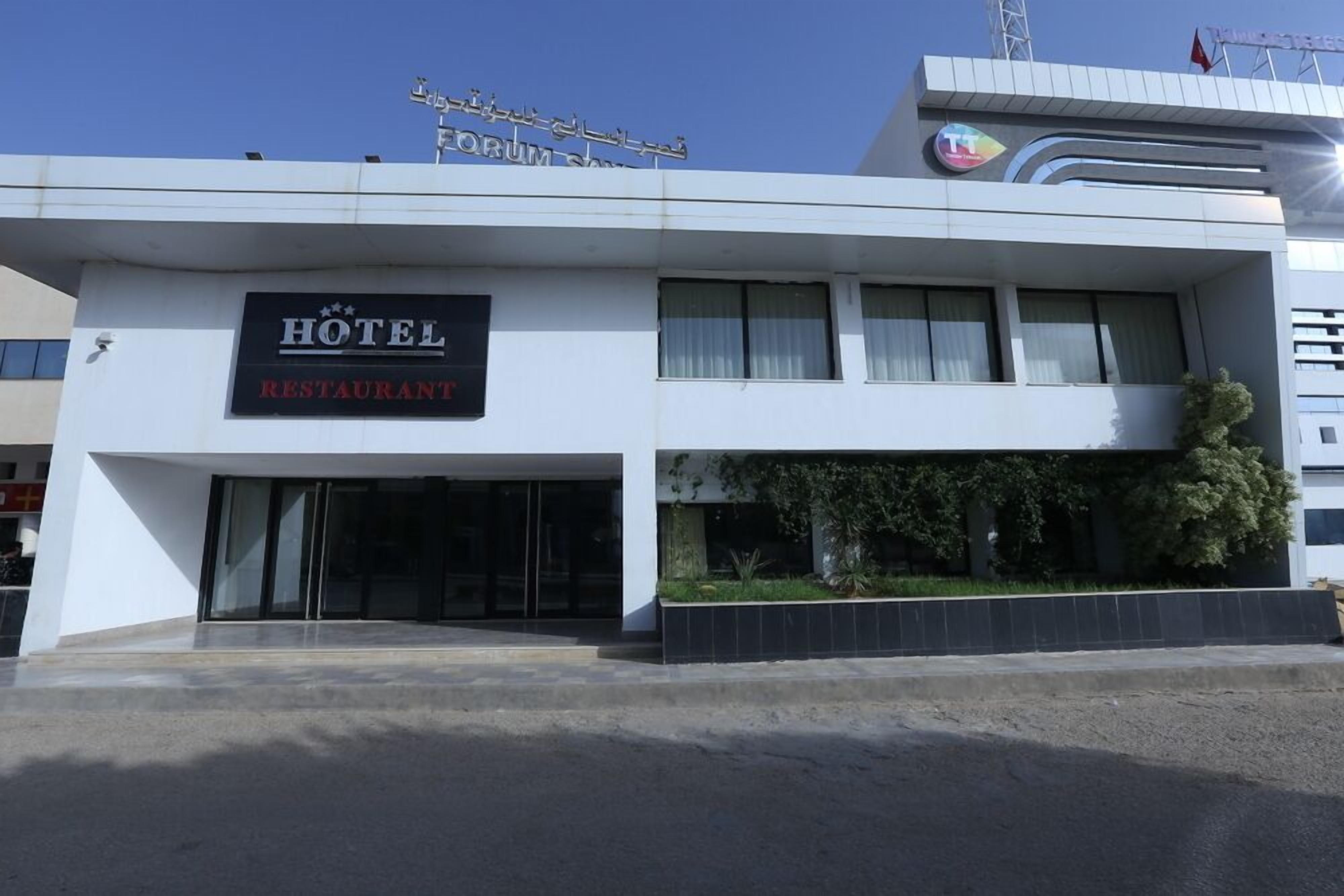 A hotel with a sign reading "HOTEL RESTAURANT" and a visible entrance.