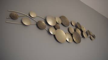 A wall-mounted abstract art installation with metallic elements.