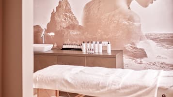 Experience relaxation and wellness in this serene spa setting, featuring a massage table and skincare products.