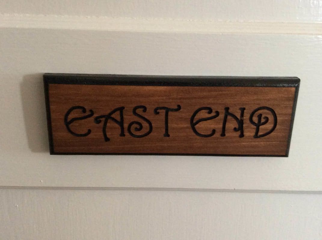 A wooden sign with the word "EASTEND" written on it.