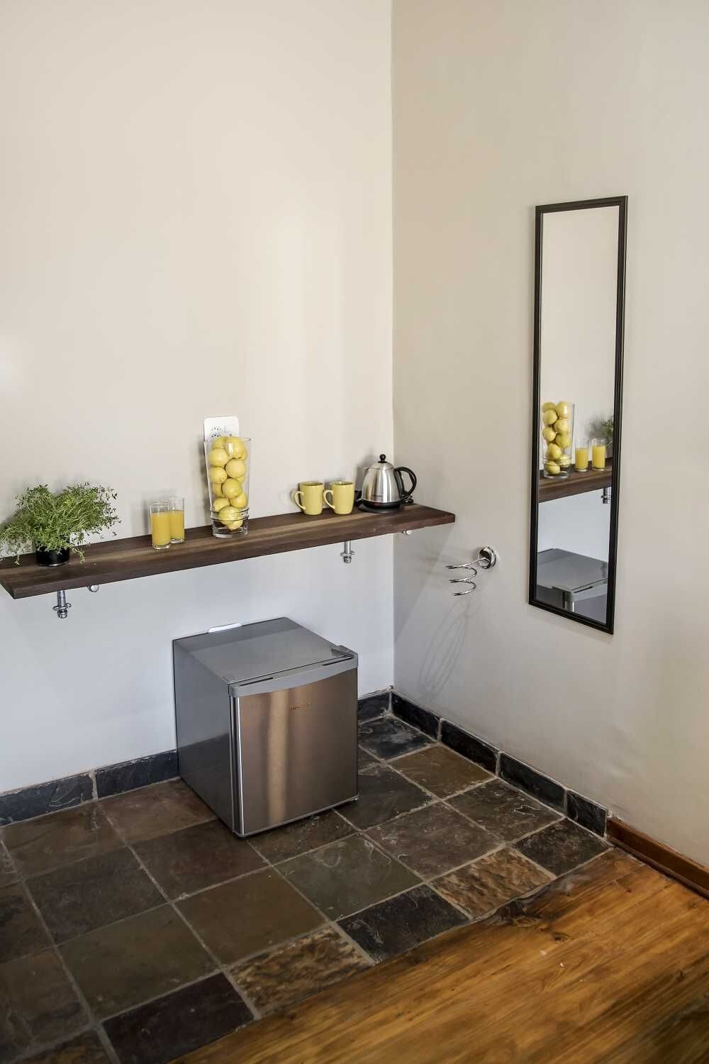 A bathroom with a shower, a toilet, and a sink with a mirror.