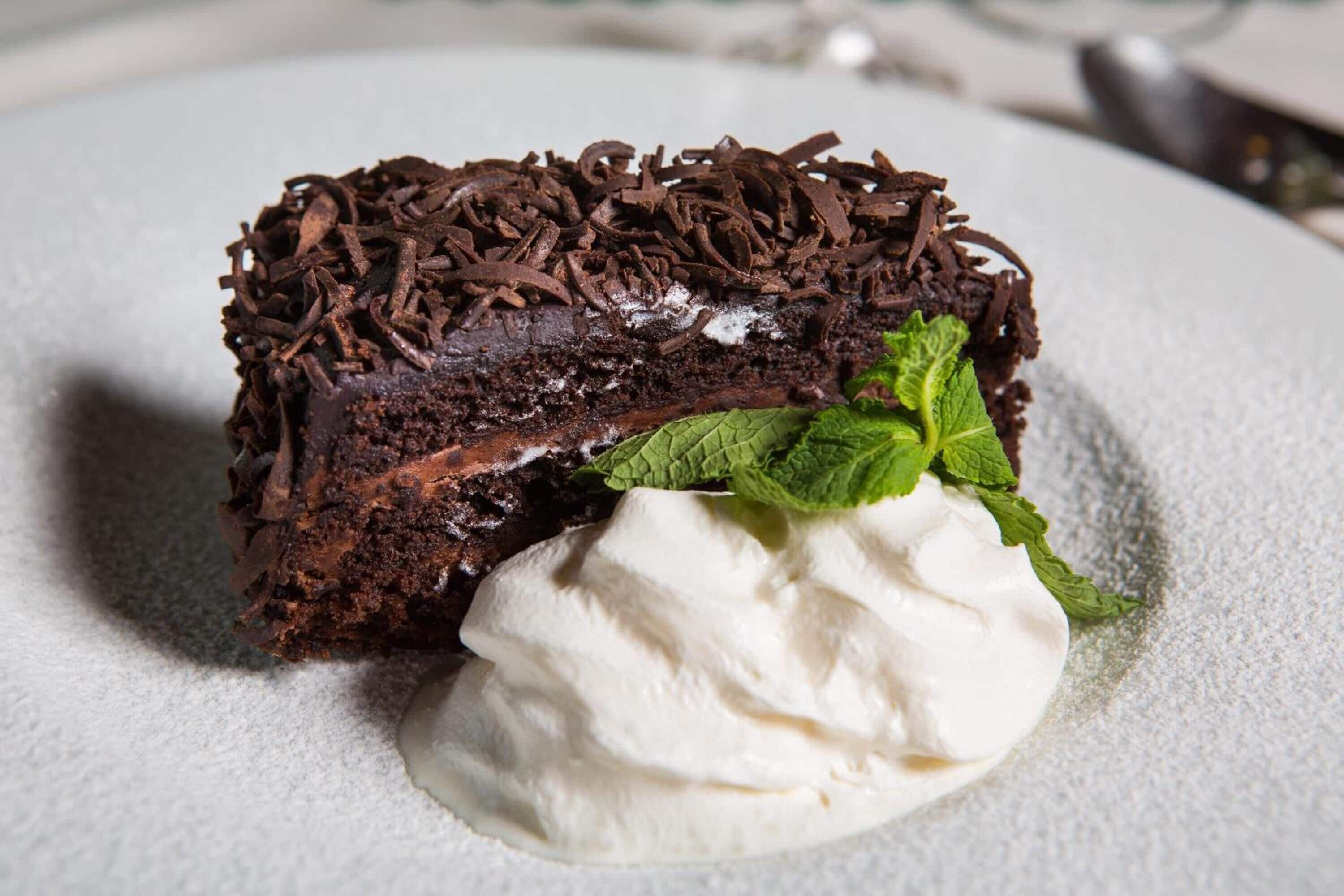 A dessert with chocolate shavings and mint leaves.