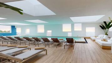 Relax by the pool surrounded by sun loungers and lush greenery.
