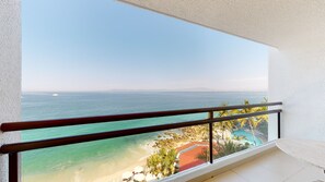 A balcony with a view of a beach, clear sky, and distant mountains. - Grand Park Royal Puerto Vallarta - All Inclusive (Puerto Vallarta)