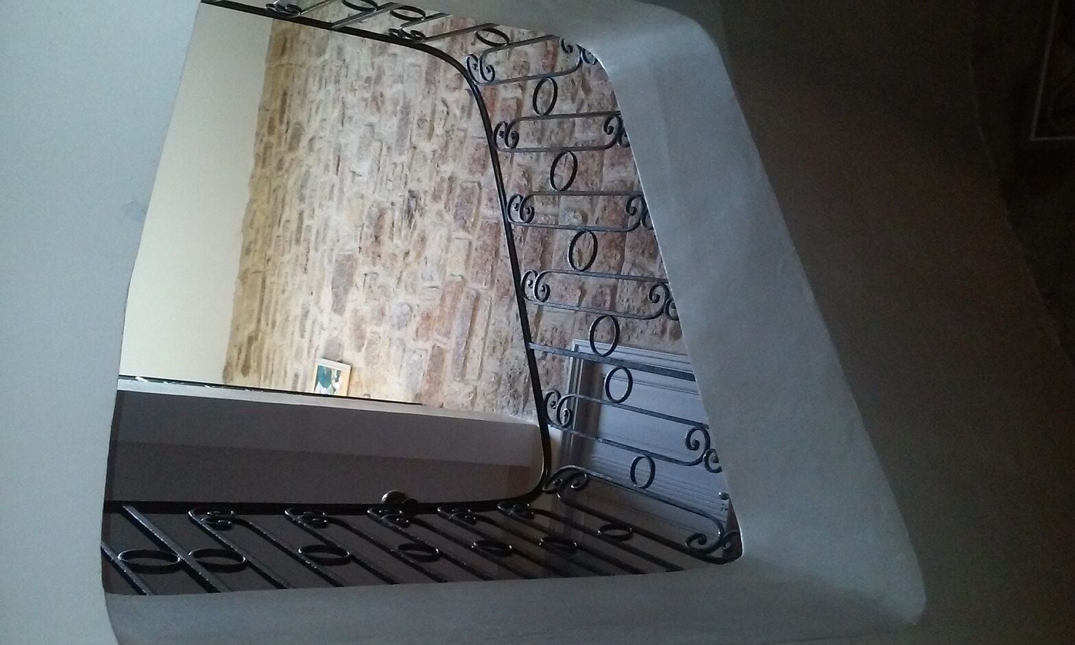A metal rack with a view of a brick wall through a window.