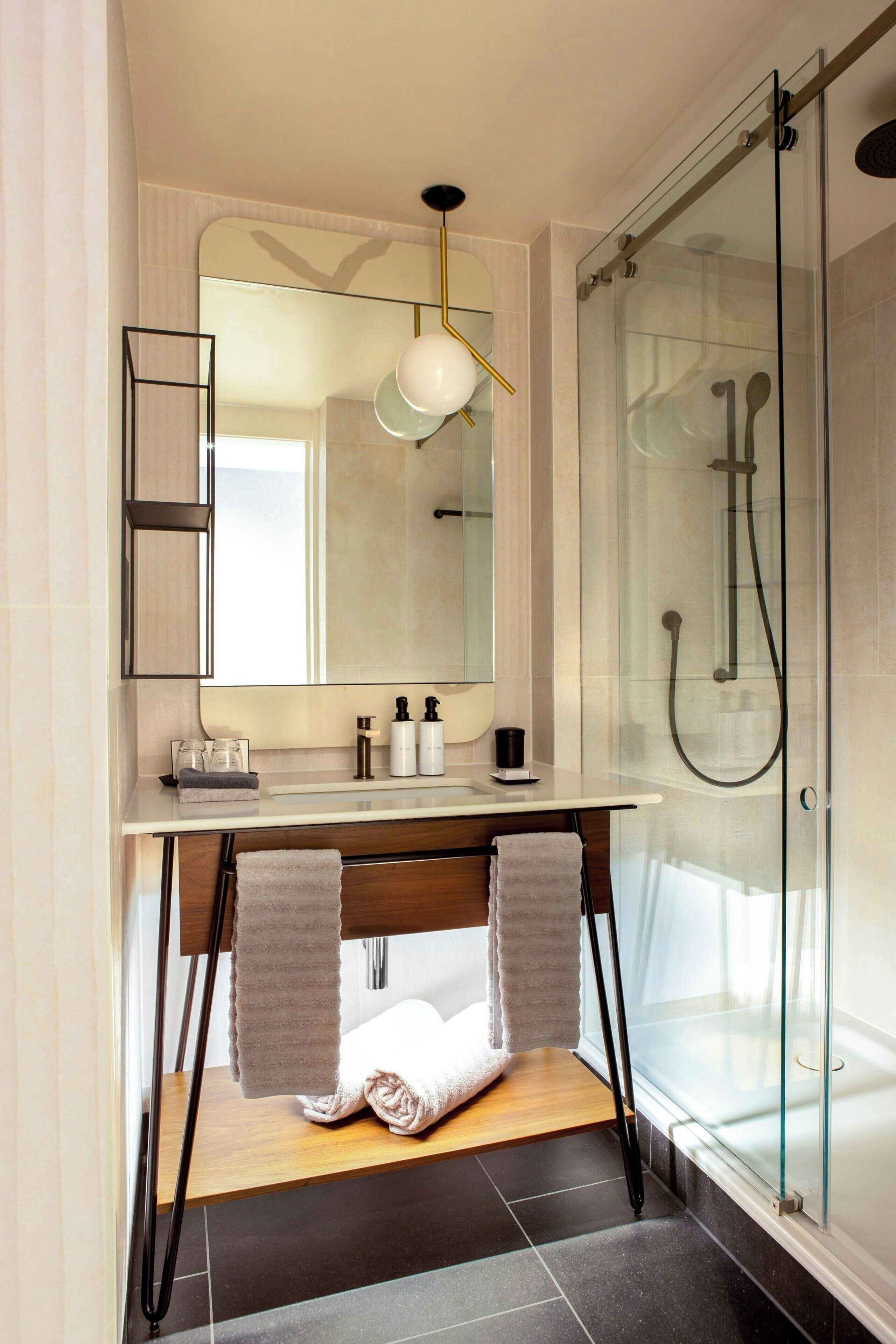 deluxe collection, 1 king bed | bathroom | eco-friendly toiletries, hair dryer, bathrobes, slippers