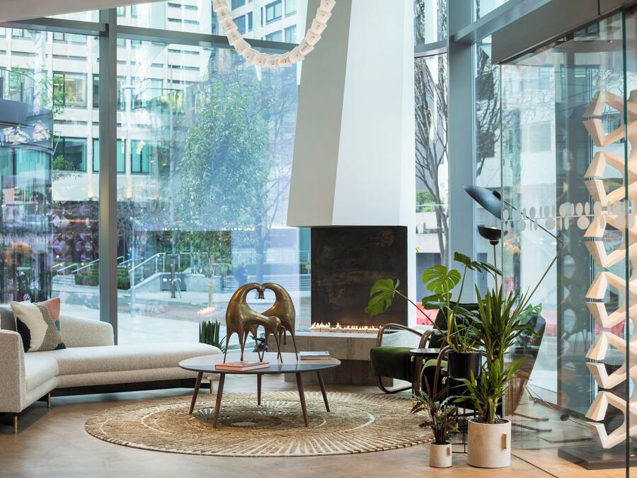 A modern living room with a sofa, coffee table, and decorative items.