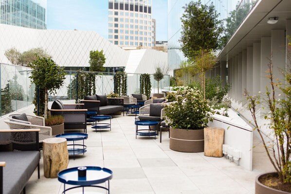 A rooftop terrace with outdoor seating, planters, and a view of the cityscape. - Bankside Hotel, Autograph Collection (London)