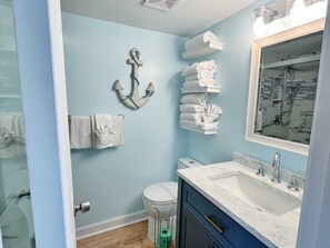 A bathroom with a toilet, sink, and towel rack. - Sunrise Ge 104 2 Bedroom Condo by RedAwning (Gulf Shores)