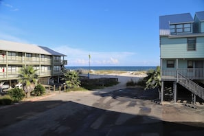 Enjoy ocean views from the balconies of this beachfront property, with access to the sandy beach via a paved driveway.