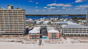 A beachfront hotel with multiple buildings, a swimming pool, and a beach area. - Harbor House B4 2 Bedroom Condo by RedAwning (Gulf Shores)