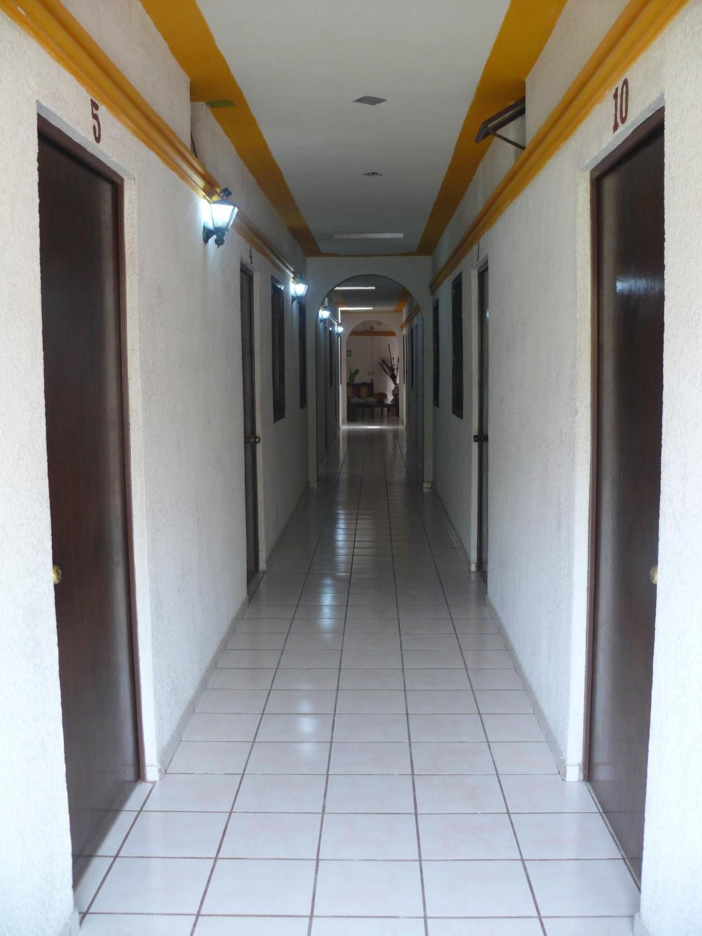 A long, narrow hallway with doors numbered 5 and 10 on either side.
