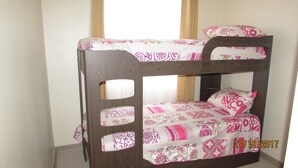 A bunk bed with floral bedding and a wooden frame. - 52.- HNA Capri (La Serena)