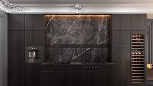 A modern kitchen with dark wood cabinetry, a marble backsplash, built-in wine rack, and a stainless steel oven. - Luxury Suites (Drama)