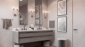 A modern bathroom with a large vanity, two wall-mounted mirrors, and framed artwork.