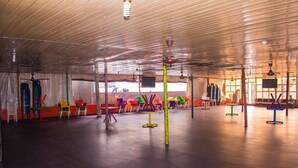 A spacious indoor area with a high ceiling, various colorful chairs, tables, and a central pole. - Jolac Hotel And Suites (Lagos)