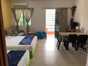 A hotel room with two beds, a desk, a chair, a TV, and a window with curtains. - Bukit Bentong Homestay (Bentong)