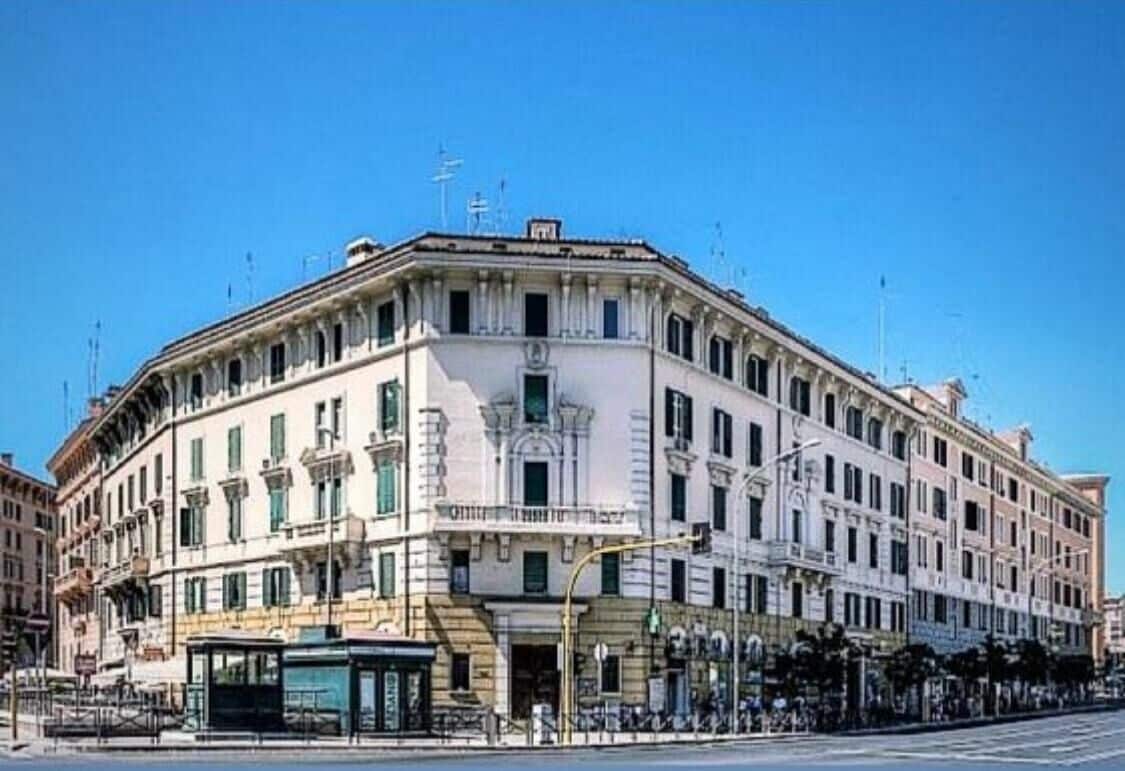 A historic building with a classical facade, large windows, and a prominent entrance.
