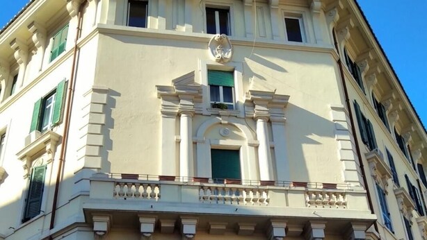 A multi-story building with a classical architectural style, featuring a central entrance with a wooden door, multiple windows with shutters, and a balcony with balustrades. - ROMAN HOLIDAYS, TWO STEPS FROM SAN PIETRO FULL OPTIONALS (Roma)