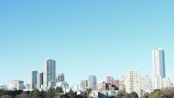 A city skyline with multiple high-rise buildings, including a prominent tall building on the right.
