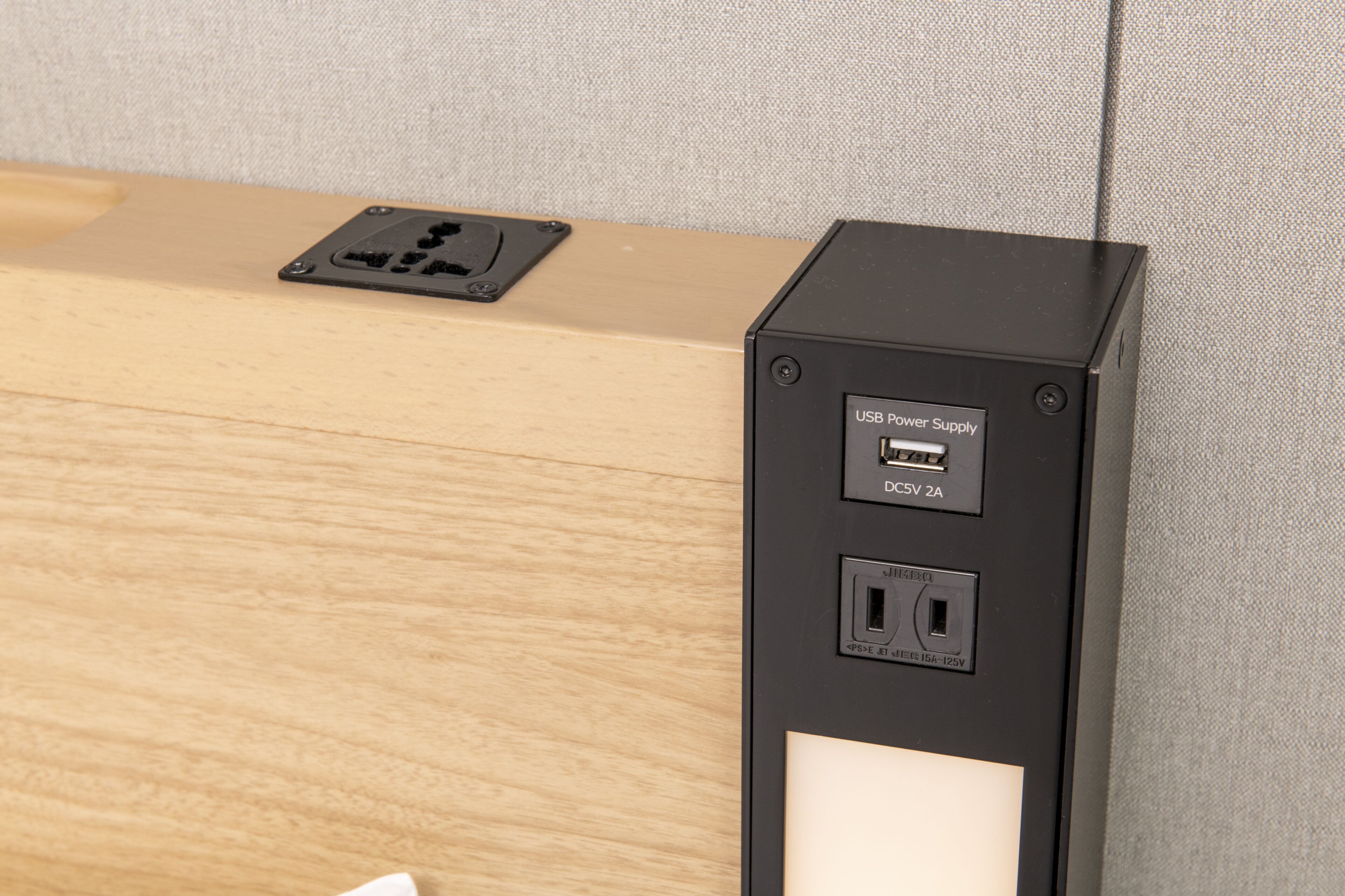 A black power supply unit with a USB port and a standard electrical outlet.
