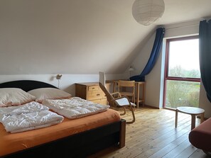 A bedroom with a bed, a desk, a chair, and a small table. - Organic vacation home, 3sleepR, 2 BathR, natural garden, sauna, WLAN, dogs allow (Altenkirchen)