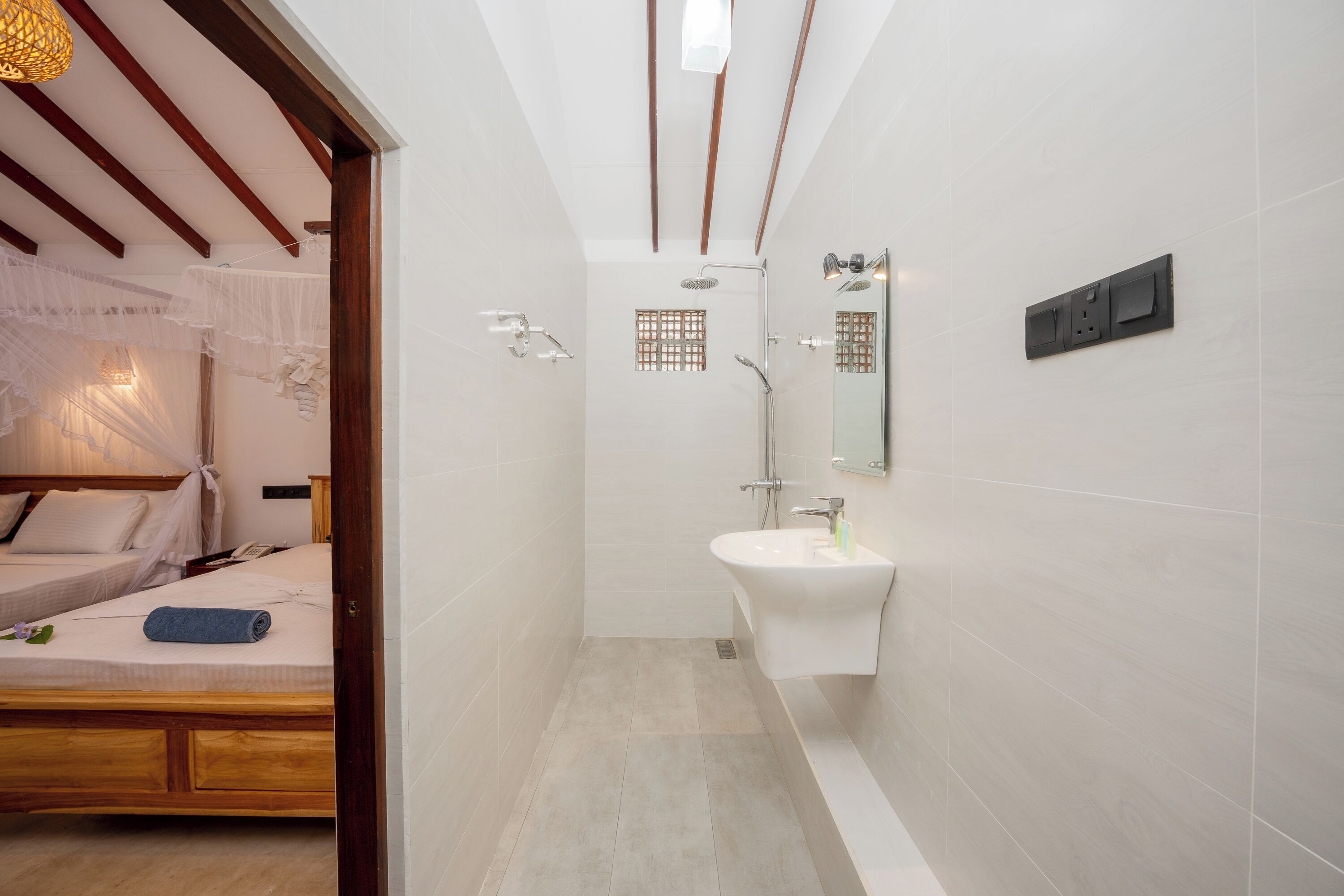 A modern bathroom with a shower, sink, and mirror.