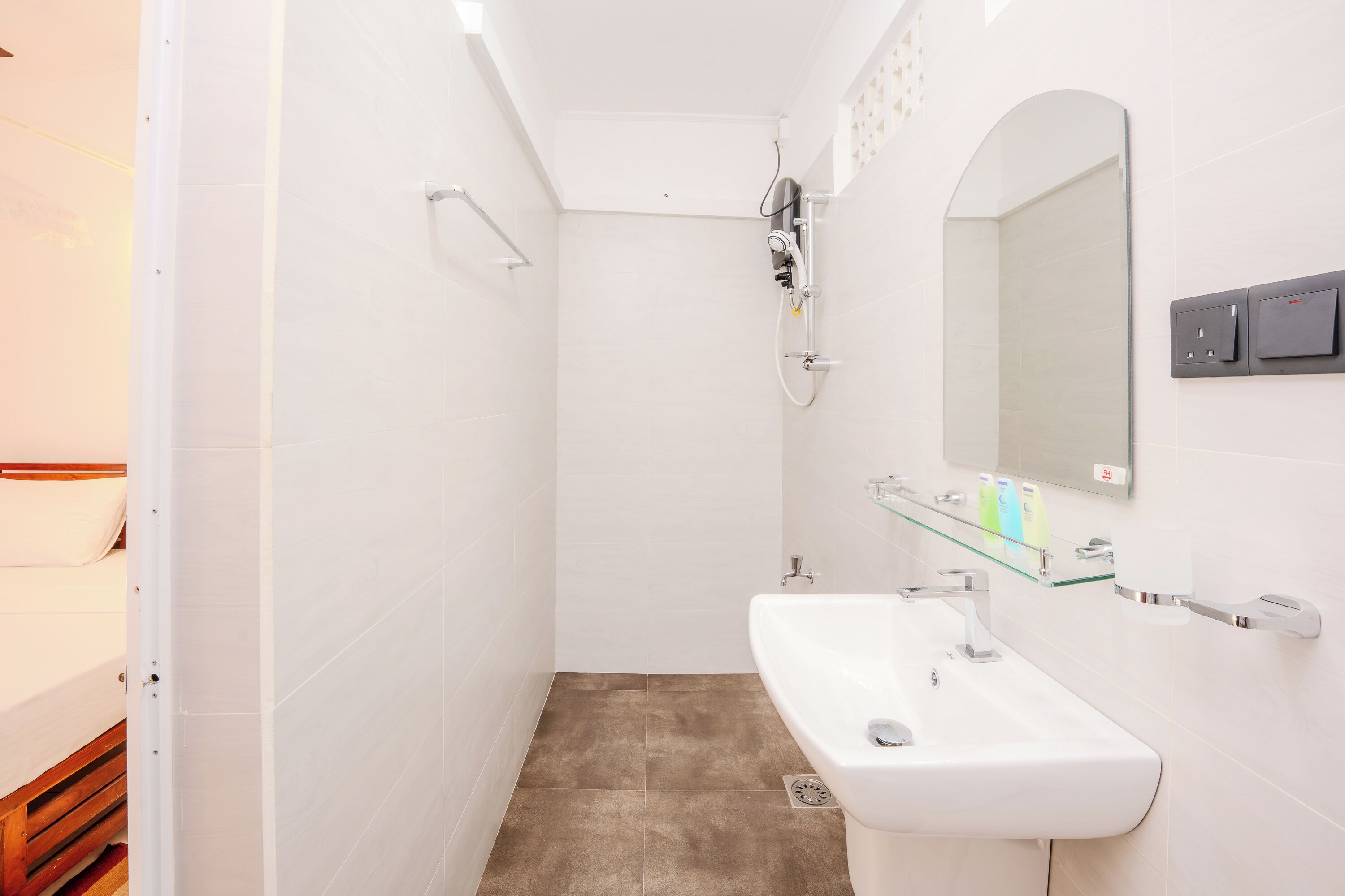 A bathroom with a shower, a sink, and a mirror.