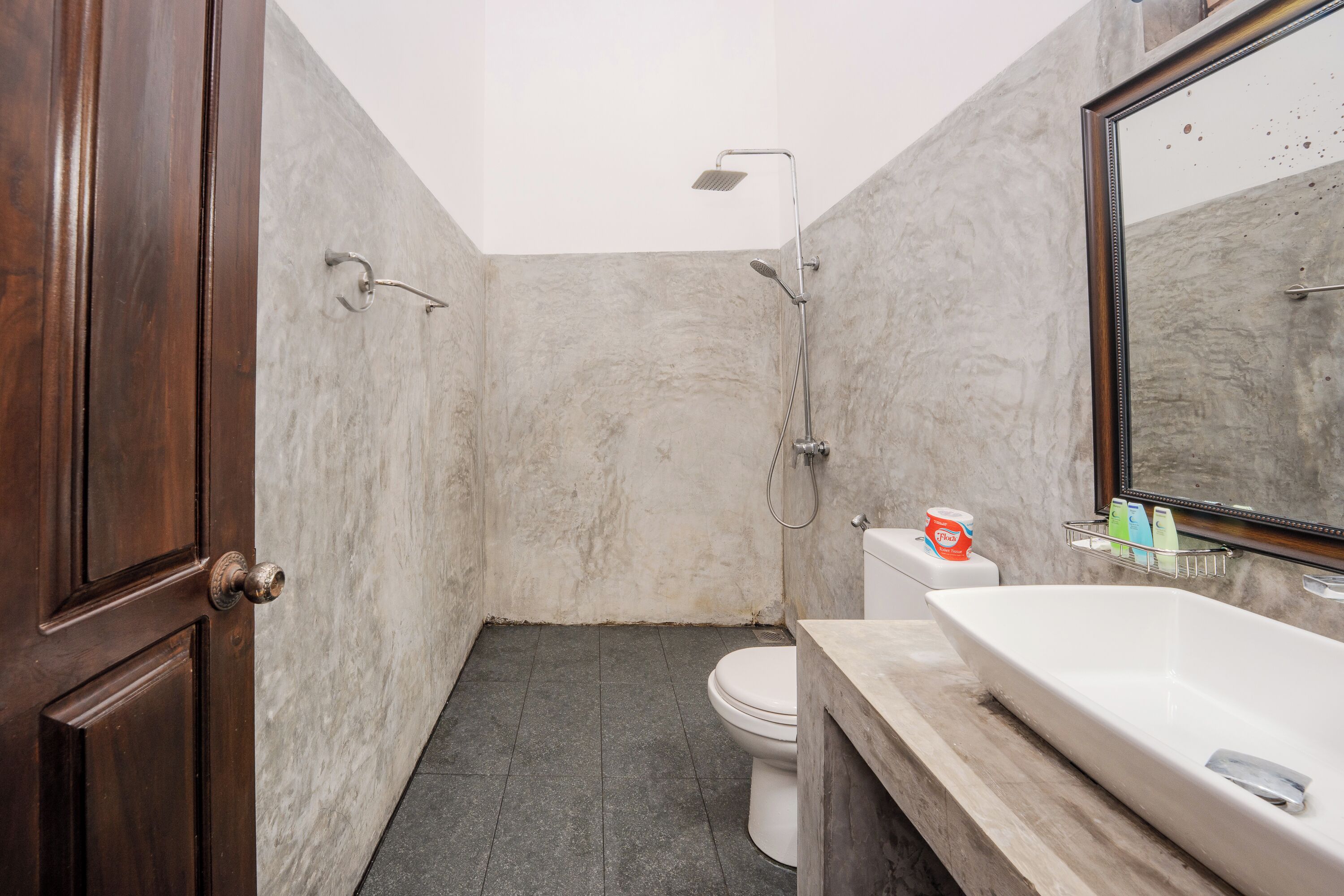A bathroom with a shower, toilet, and sink.