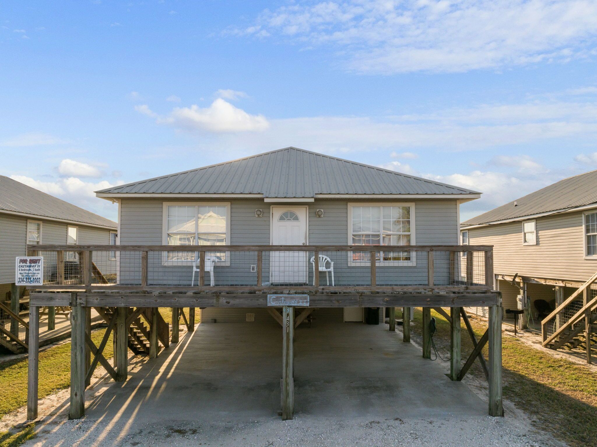 A single-story building with a covered porch, a front door, and a small attached garage.