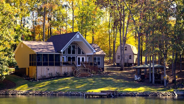 A lakeside cabin with a dock, surrounded by trees and a grassy area. - Private Lakeside, private Dock, Outddor Kitchen Fire Pit & More (Chappells)