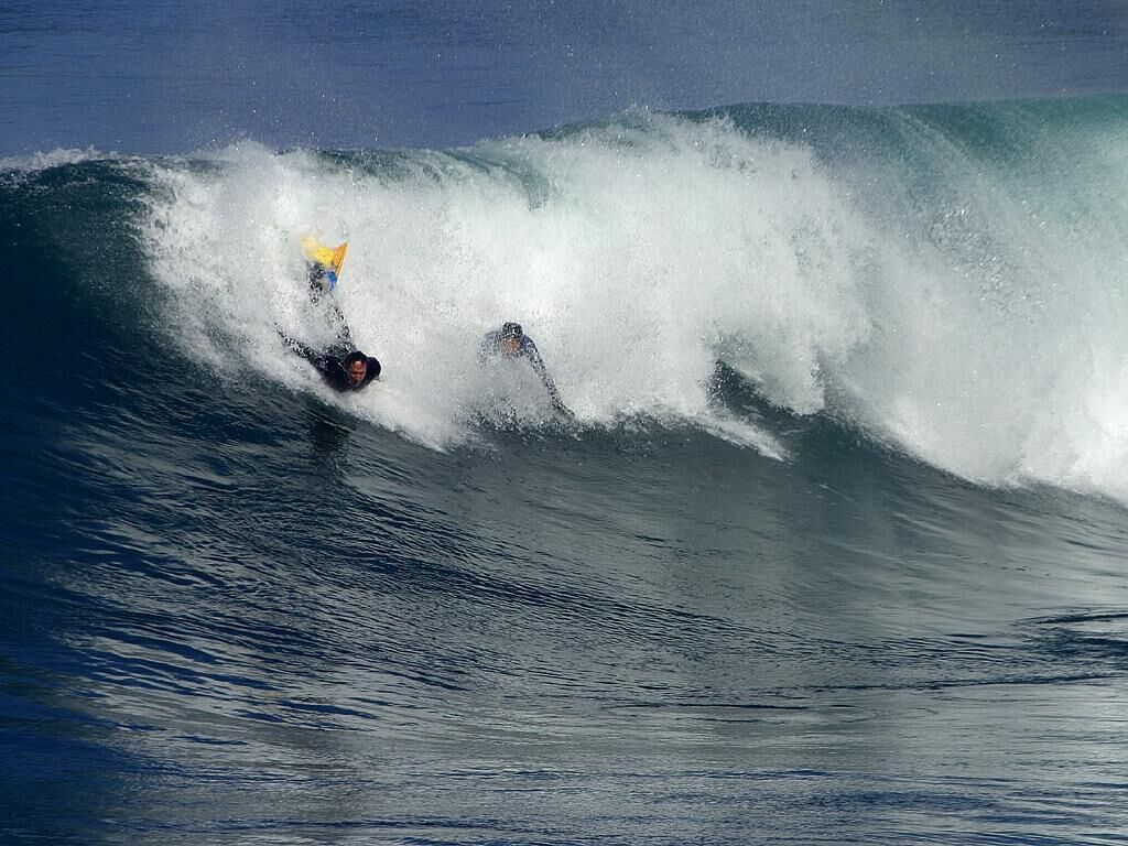 A surfer riding a large wave.